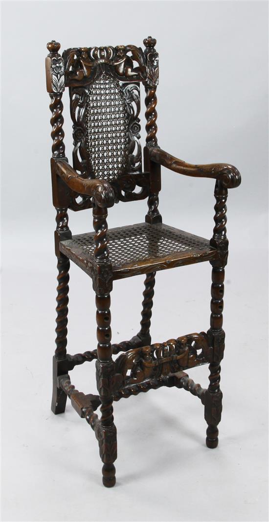 A Victorian Carolean style carved oak childs high chair, H. 3ft 8in.